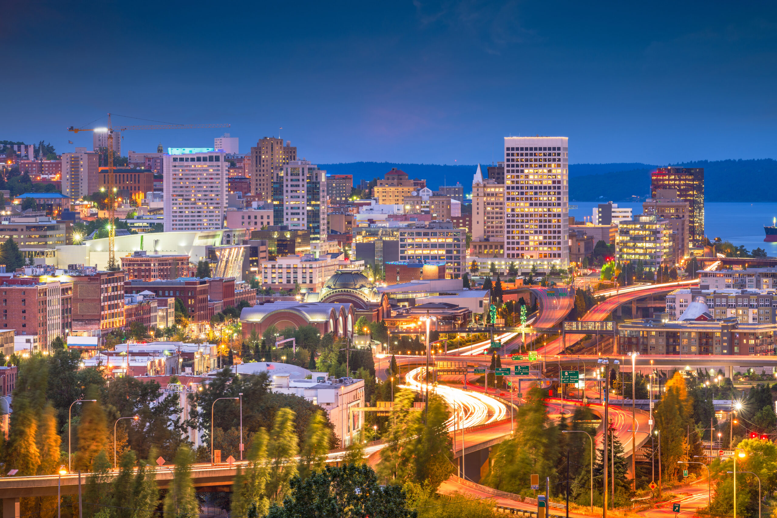 Nighttime skyline of downtown Tacoma, WA with city lights and freeways